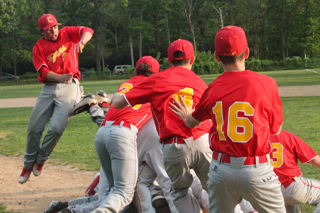 Enraptured by the glory of winning the league championship, the JV baseball team dogpile on top of one another in a pure expression of camaraderie.