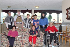 The volunteers don a variety of costumes as they spend time with the residents of Queen of Peace.  